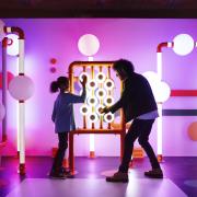 Visitors playing in the musical playground in Turn It Up exhibition
